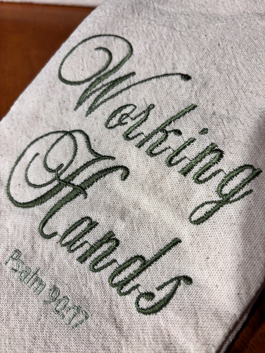 Textile with 'Working Hands' embroidery and Psalm 90:17 text.