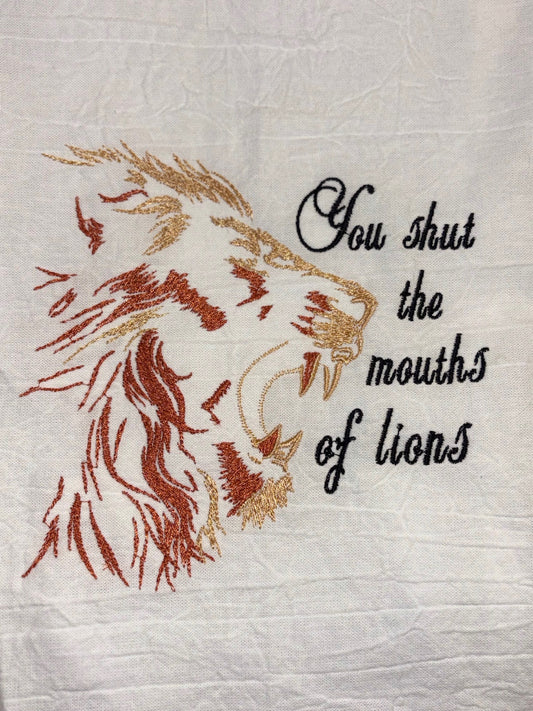 Embroidered design of a lion with text on a textured fabric background